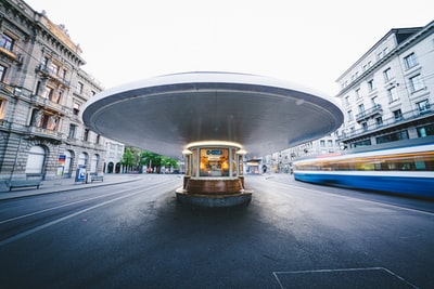 The vehicle in the daytime gray cement road
